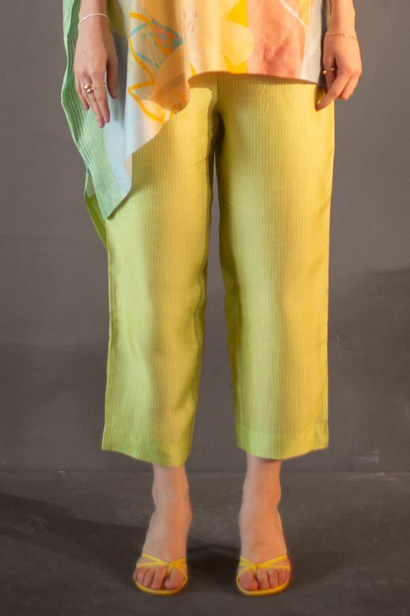 Lime asymmetric kaftan with abstract geometric and floral print. Paired with striped straight pant. - Aza Fashions Silk Bottoms With Asymmetrical Hem For Spring, Spring Silk Bottoms With Asymmetrical Hem, Spring Sets With Side Slits, Green Straight Pant Set For Summer, Green Summer Pant Set With Straight Pants, Elegant Pants With Asymmetrical Hem For Summer, Elegant Summer Pants With Asymmetrical Hem, Chic Sets With Asymmetrical Hem For Spring, Elegant Green Summer Pant Set