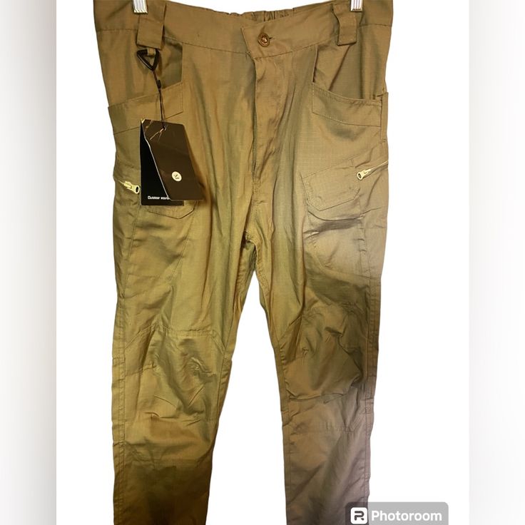 Nwt Tactical Utility Pants Tan Outdoor Medium Outdoor Equipment Multiple Pockets Flat Lay Measurements Waist 16” Length 40” Inseam 28” Ankle 7” Smoke Free Pet Friendly Home Thanks For Shopping With Me And If You Have Any Questions Please Let Me Know 9 Tactical Khaki Pants For Outdoor, Khaki Techwear Cargo Pants For Hiking, Techwear Khaki Cargo Pants For Hiking, Combat Style Khaki Work Pants For Outdoor, Tactical Khaki Bottoms For Outdoor Activities, Khaki Tactical Outdoor Work Pants, Tactical Khaki Hiking Bottoms, Tactical Khaki Work Pants For Outdoor, Combat Style Khaki Cargo Pants For Hiking