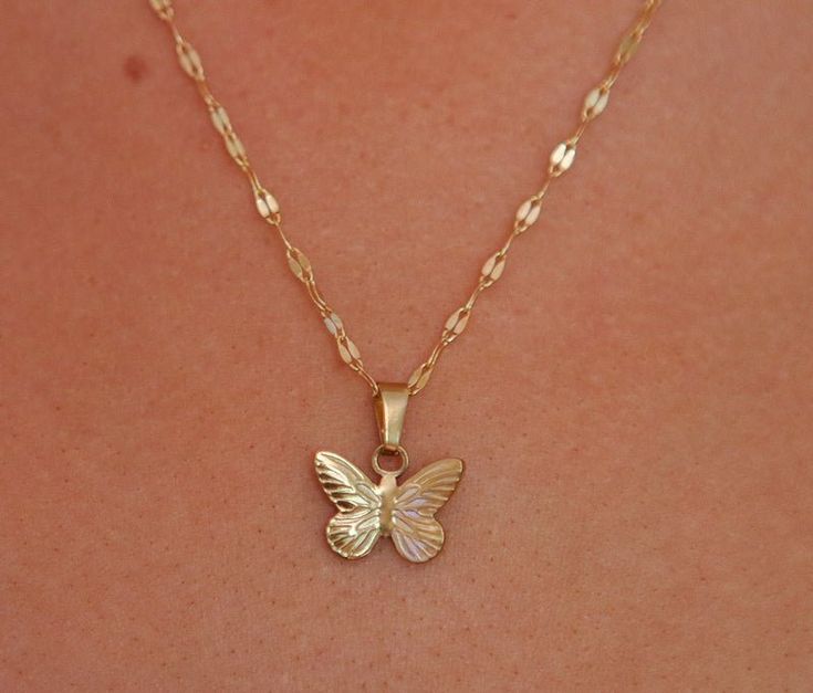 Introducing our Butterfly Charm, a delicate and enchanting addition to your jewellery collection. This charming pendant features the graceful silhouette of a butterfly, capturing the essence of transformation, freedom, and natural beauty. Crafted with meticulous attention to detail, the Butterfly Charm is a symbol of metamorphosis and the fleeting beauty of nature. Its intricate design showcases delicate wings with subtle details that add a touch of elegance to any necklace. Designed to be paire Butterfly Charm Jewelry As Gift For Her, Dainty Butterfly Jewelry With Delicate Chain, Delicate Butterfly Charm Necklace As A Gift, Butterfly Necklace As Gift For Her, Handmade Minimalist Butterfly Jewelry, Butterfly Charm Jewelry Gift, Delicate Butterfly Jewelry For Gifts, Dainty Butterfly Shaped Jewelry With Delicate Chain, Delicate Butterfly Necklace With Delicate Chain