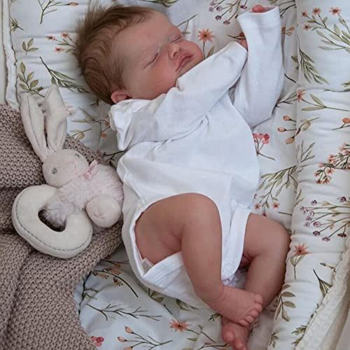 a baby is sleeping in a crib next to a stuffed animal