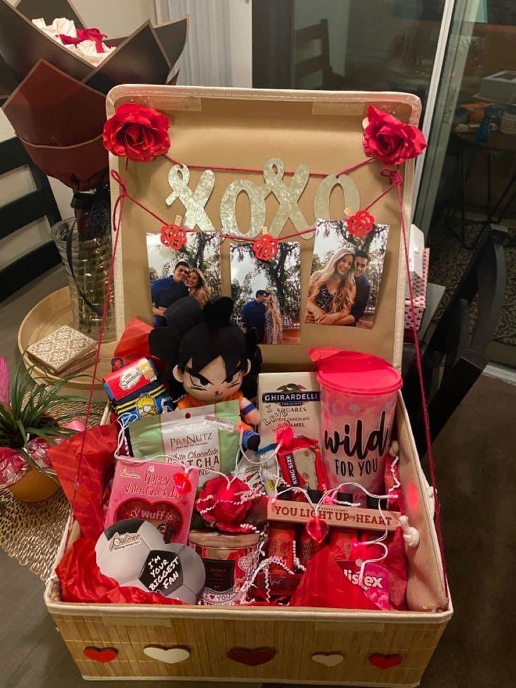 an open suitcase filled with valentine's day items and gifts for someone to put in it