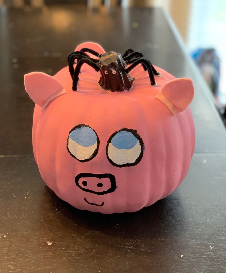 a pink pig shaped pumpkin sitting on top of a table