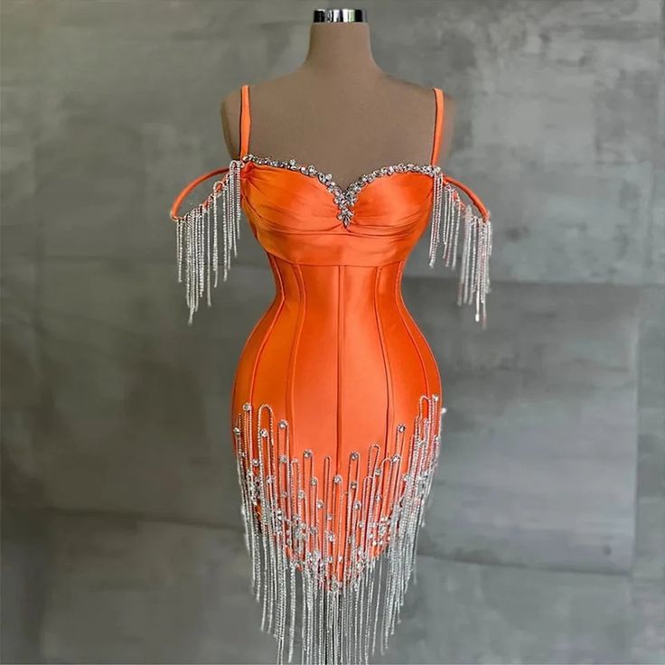 Turn heads and make a dazzling entrance with our Luxe Crystal Fringe Satin Dress. This stunning piece is a perfect blend of elegance and glamour, designed to make you the center of attention at any event. Crafted from high-quality satin, this dress offers a smooth, lustrous finish that radiates sophistication. The radiant orange hue adds a bold splash of color that effortlessly enhances your natur.. Glamorous Satin Evening Dress For Gala, Satin Mini Dress For Banquet During Prom Season, Party Season Evening Dress With Beaded Straps, Embellished Satin Evening Dress For Banquet, Embellished Satin Evening Dress For Banquets, Embellished Satin Dress For Banquet, Embellished Satin Dress For Banquets, Satin Prom Dresses With Rhinestones, Satin Dress For Gala Party