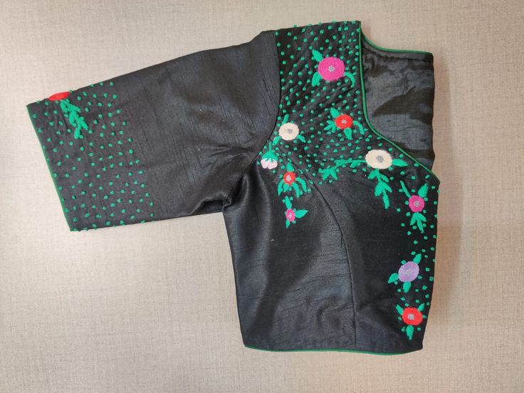 Beautiful black designer saree blouse with colorful embroidery. Buy designer blouse in USA from Pure Elegance. Disclaimer: The actual product may vary slightly from the image. These are custom orders, hence expect slight variation in color, placement of the motif or buta. ESTIMATED DELIVERYBecause this is a custom order, it would take about 2 weeks from the date of purchase. RETURN POLICY: This product is a custom order and cannot be returned or exchanged. Black Semi-stitched Embroidered Fabric With Pallu, Unstitched Floral Embroidery Blouse For Navratri, Designer Black Tops For Festive Season, Designer Black Tops For Festive Occasions, Designer Embroidered Black Saree, Designer Embroidered Black Blouse Piece, Black Embroidered Saree Fabric With Pallu, Black Embroidered Designer Blouse Piece, Traditional Black Choli With Motifs