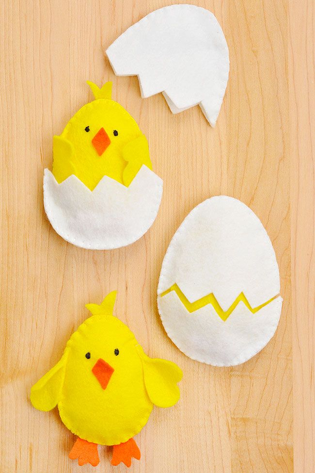 paper mache chicks and an egg on a wooden surface