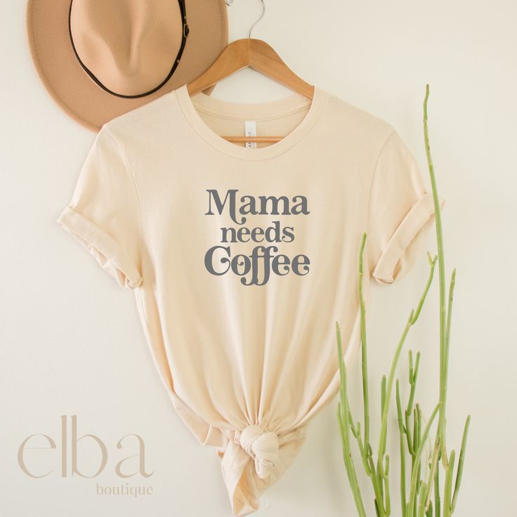 Mama needs Coffee Shirt, pictured in the color Soft Cream. Mamacita Collection Unisex Jersey Short-Sleeve T-Shirt Mom Shirt ~ Women's Shirt Be Aware that these are unisex shirts, Please review the size chart I have provided in the pictures. ~ABOUT T-SHIRT~ * Unisex Jersey Short-Sleeve * White - 4.2 oz 100% airlume combed and ringspun cotton * High Quality Commercial Grade Heat Transfer Vinyl COLOR OF T-SHIRT WILL VARY SLIGHTLY DUE TO LIGHTING AND COMPUTER MONITOR The last picture is direct from Coffee Graphic Print Top For Summer, Coffee Graphic Print Tops For Summer, Casual Coffee Pre-shrunk Tops, Summer Coffee Colored Tops With Graphic Print, Coffee Color Graphic Print Summer Top, Relaxed Fit Coffee Tops With Graphic Print, Coffee Colored Relaxed Fit Tops With Graphic Print, Coffee Color Cotton Top For Summer, Casual Coffee Colored Top For Everyday