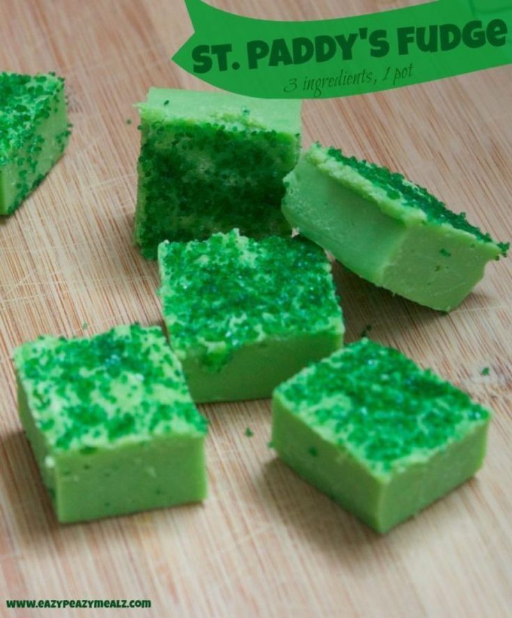 several pieces of green cake sitting on top of a wooden cutting board with the words st paddy's fudge