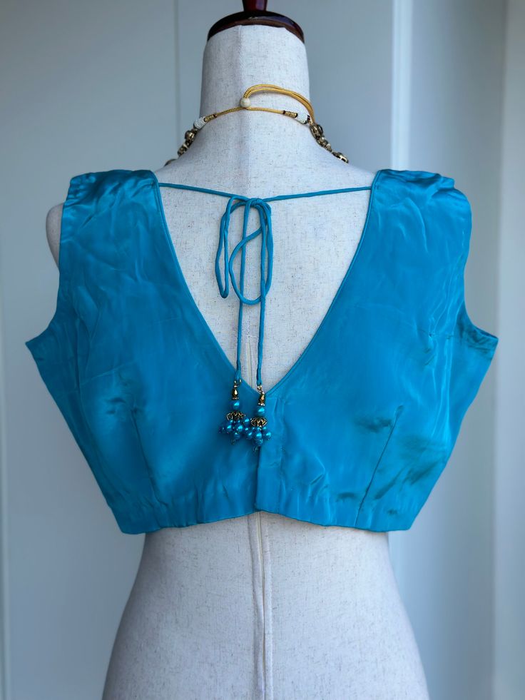 Blouse size 38-42 crape silk sleeveless blouse Blue Silk V-neck Blouse, Elegant Silk Blouse Piece With V-neck, Silk Sleeveless Blouse For Party, Silk V-neck Blouse For Party, Elegant V-neck Silk Blouse Piece, Satin Sleeveless Party Blouse, Elegant Sleeveless Satin Blouse, Sleeveless Padded Blue Blouse, Sleeveless Padded Blouse In Blue