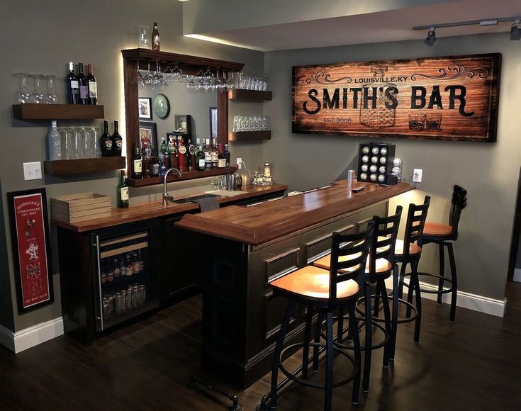 a bar with several stools in front of it and a sign that says smith's bar on the wall