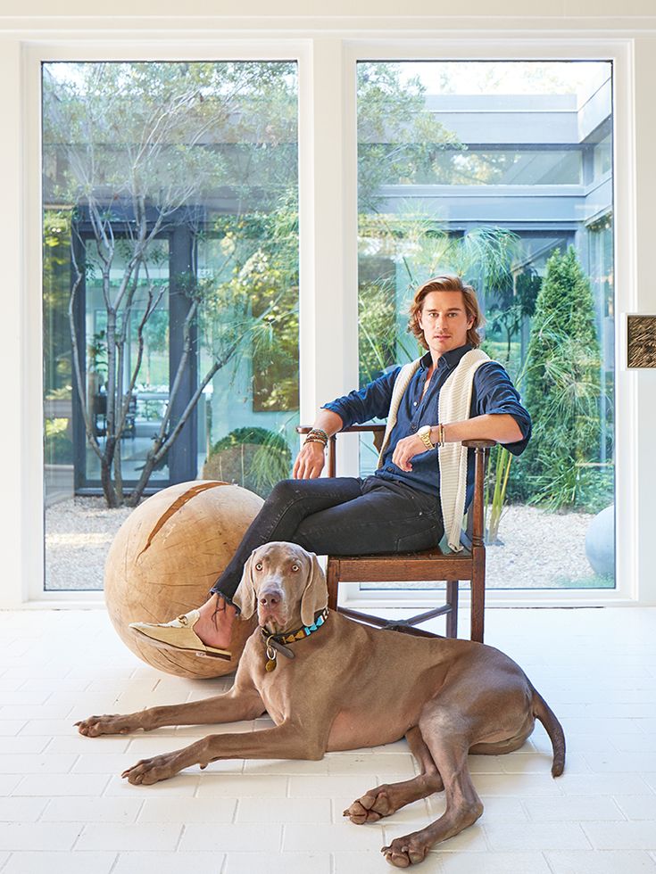 a woman sitting in a chair next to a dog