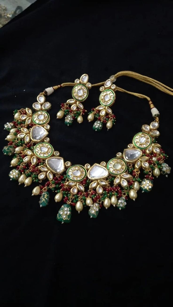 Designer Kundan Haar,Tanjore kundan jewelery,bridal kundan haar,multi color kundan haar,sabyasachi bridal set,kundan set,Indian kundan. This long kundan haar is made with premium quality meena kundans with embellished jhumke & Tanjore beads. Comes in a combination of pastel green & light pink and in single colors. Shade of the kundan - Golden (not dull golden or copper color) Bridal Choker Set, Gray Beaded Necklace, Kundan Choker, Bridal Choker, Kundan Set, Bridal Necklace Set, Kundan Necklace, Pakistani Jewelry, Choker Set