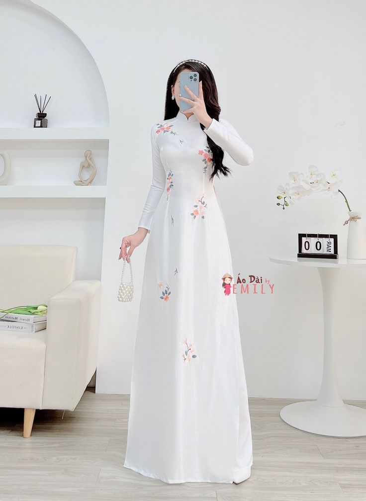 🌻Material: Lụa vân gỗ 🌻Stretchy level: 2/10 🌻 The measurement of this ao dai (long dress) is in Vietnamese size (American size tends to be bigger for the same size). Please LOOK AT THE SIZE CHART CAREFULLY BEFORE ORDERING. There might have some chalk writings on the fabric due to making process. These marks can be washed away easily. 🌻🌻No returns or exchanges Buyer can contact seller about any issues with an order. 🌸 Follow us Facebook/aodaiemily www.aodaiemily.com 💜 Thank you very much💜 Elegant White Cheongsam For Spring, Traditional White Summer Cheongsam, Traditional White Cheongsam For Summer, Traditional White Cheongsam For Spring, White Embroidered Ao Dai For Wedding, Traditional White Fitted Cheongsam, Traditional White Long Sleeve Ao Dai, White Long Sleeve Ao Dai, Fitted Embroidered White Cheongsam