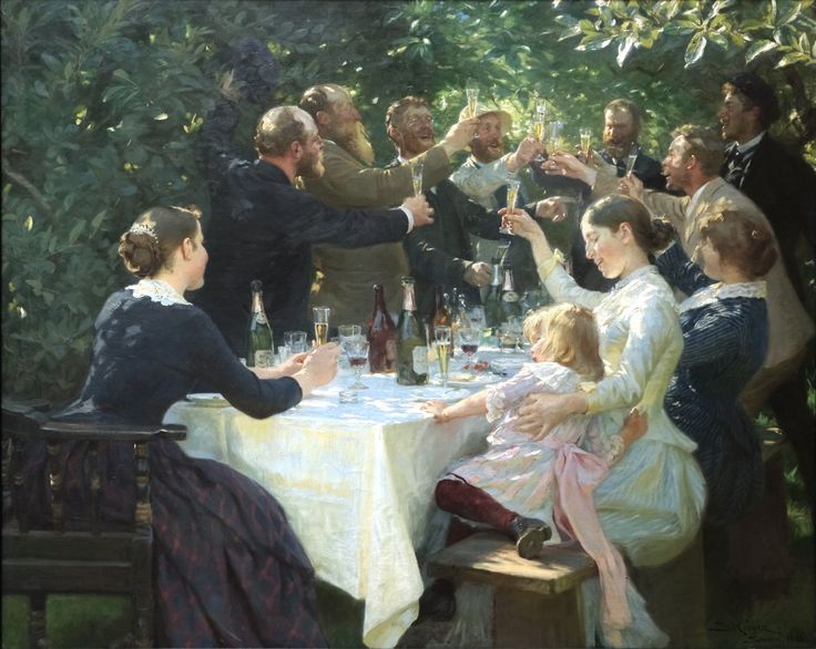 a group of people sitting around a table drinking wine