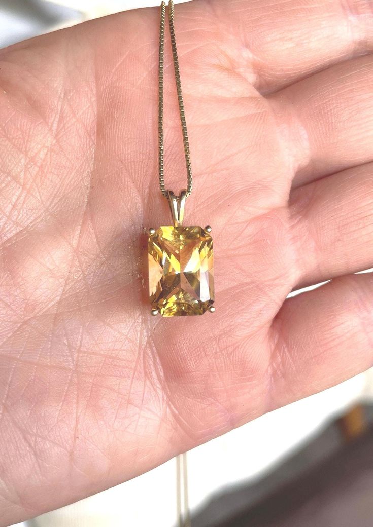 Exquisite golden yellow topaz emerald cut prong set in 14k yellow gold pendant. Not often do you find this carat size in a natural golden yellow topaz. Absolutly gorgeous piece. The clarity and sparkle of the stone is really excellent. The bale is made large enough to accommodate any number of different chains.  Its a substantial stone 14mm x 10mm approximate carat weight 10.22, length w/bale 7/8" width 1/2", gram weight 2.9. A November birthstone stunner.  It's not recommended to clean topaz in a vibrating jewelry cleaner. It's best to use a soft brush mild soap and only warm water not hot.  Topaz is said to bring joy and I'm certain that would be true for the wearer of this beauty. This piece comes from an estate. Near mint to mint vintage condition. Thank you for stopping in to look Yellow Rectangular Stone Jewelry For Formal Occasions, Classic Gold Topaz Jewelry, Classic Yellow Gold Jewelry With Topaz, Emerald Cut Topaz Jewelry With Diamond Cut, Radiant Cut 14k Gold Jewelry, Gold Topaz Jewelry With Diamond Cut, Classic Citrine Jewelry With Diamond Cut, Gold Topaz Jewelry With Emerald Cut, Fine Jewelry With Rectangular Topaz Stone