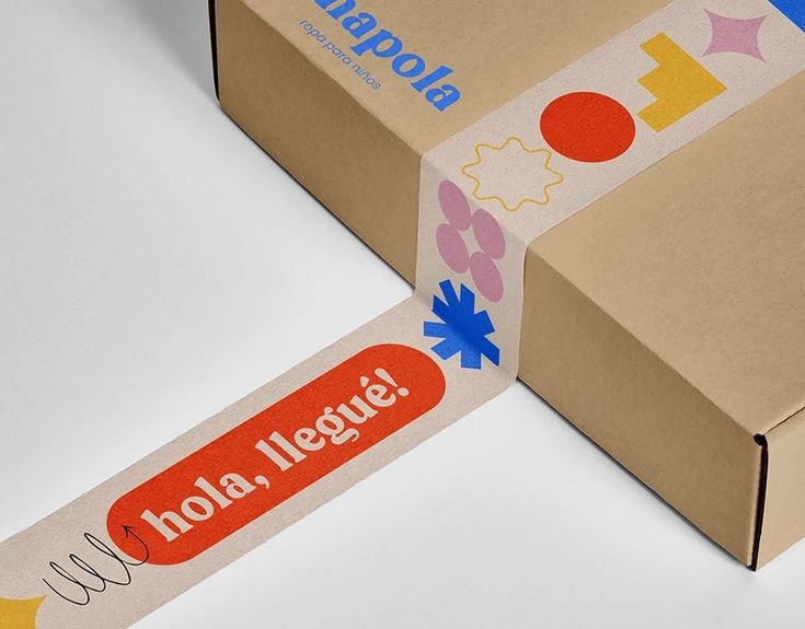 an open box with a sticker on it sitting next to a cardboard box that says kola league