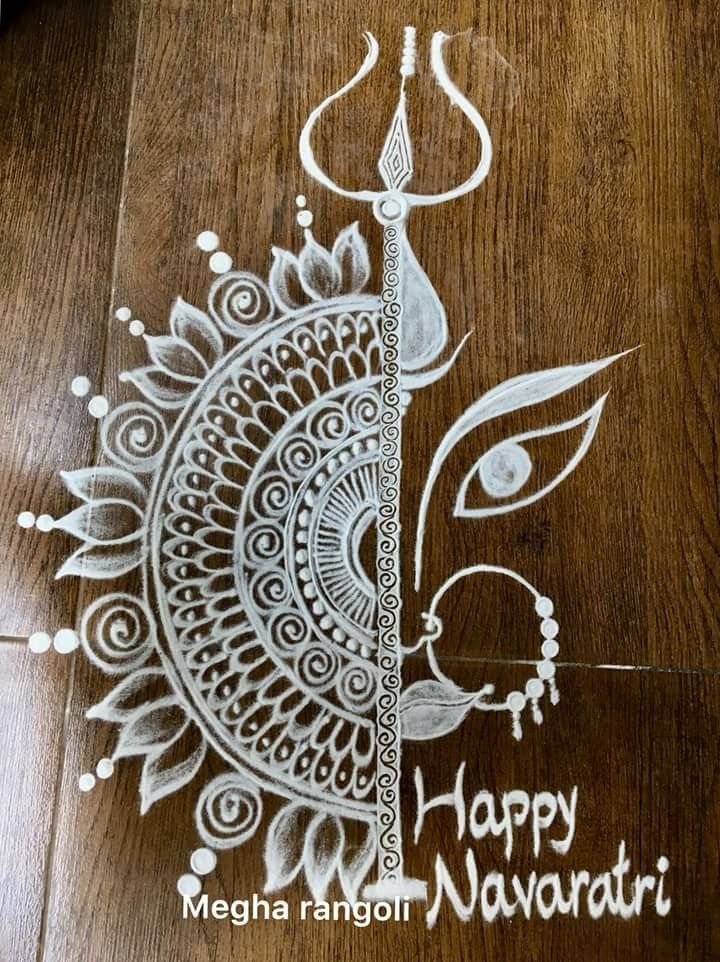 a drawing on the floor that says happy navratri with an artistic design