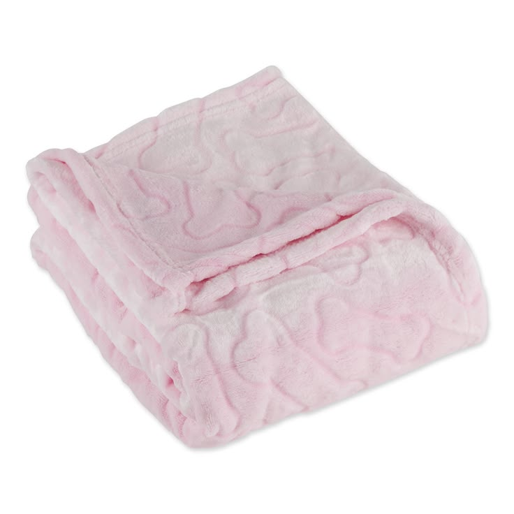 the pink blanket is folded up on top of it's white base and features hearts