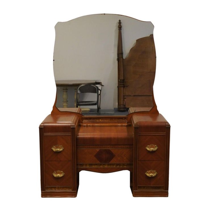 an antique wooden desk with mirror and chair