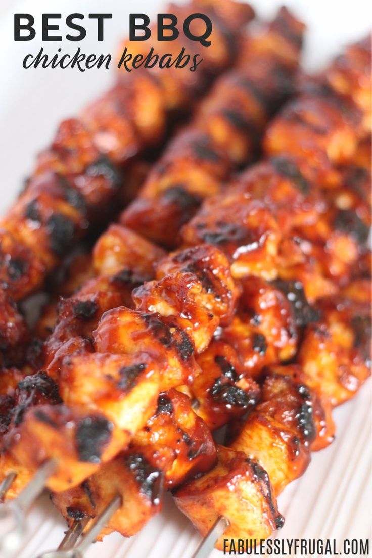 bbq chicken kebabs on a white plate