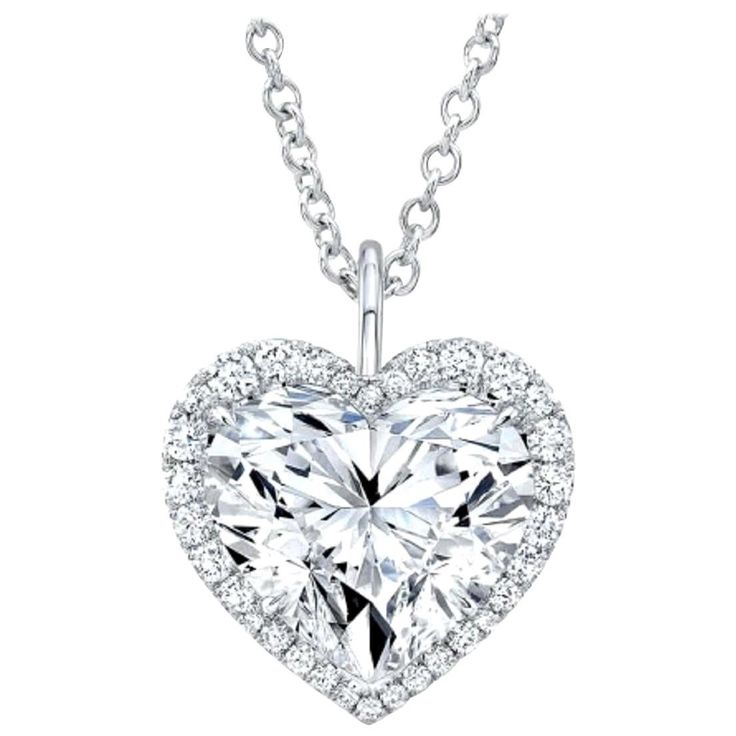 Introducing a stunning GIA Certified 5 Carat Heart Shape Diamond Pendant, elegantly suspended from an 18K white gold chain. The diamond boasts a color grade of F and a clarity grade of VS2, ensuring a beautiful near-colorless appearance and remarkable clarity. With excellent polish and symmetry, the diamond radiates exceptional brilliance and precision. Free from fluorescence, the pendant maintains its pure sparkle in all lighting conditions. This exquisite piece epitomizes timeless elegance and superior craftsmanship, with the GIA certification guaranteeing its quality and authenticity. Heart Shaped Diamond Necklace, Heart Shaped Diamond Pendant, Art Deco Pendant Necklace, Marquise Shape Diamond, White Gold Chain, Heart Shaped Pendant Necklace, White Gold Chains, Halo Pendant, Heart Shaped Diamond