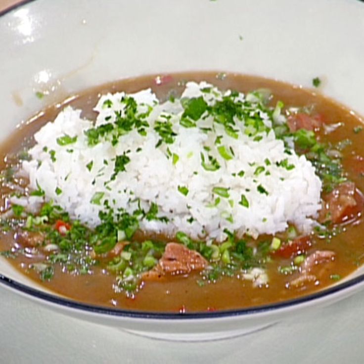 a bowl filled with rice and beans on top of a table