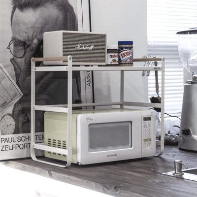 a microwave sitting on top of a wooden counter