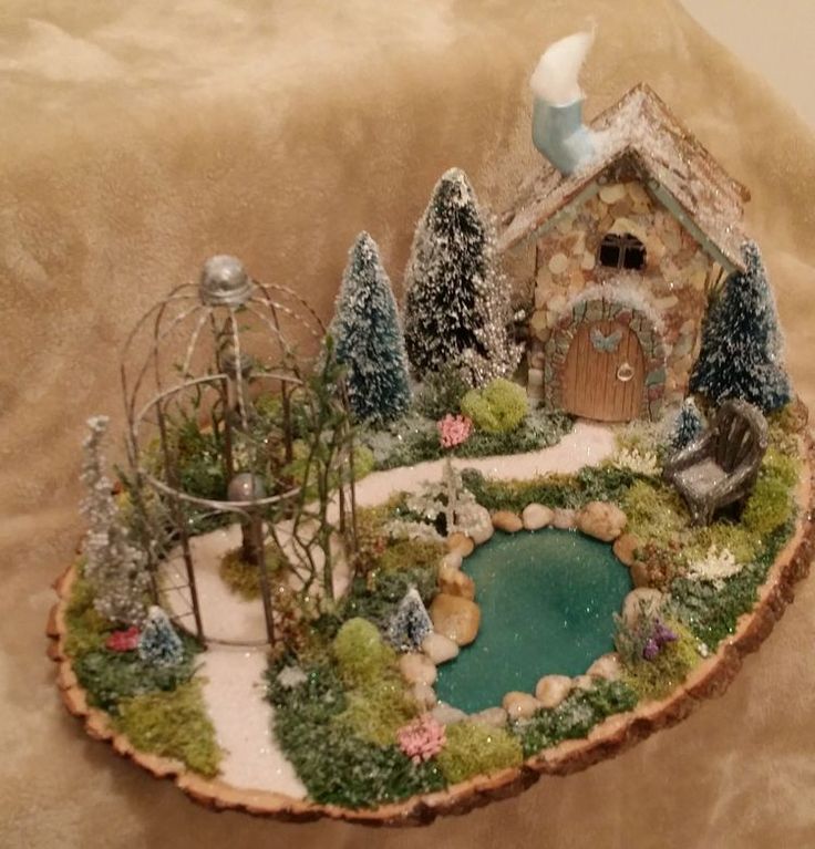 a miniature house with a pond in the middle