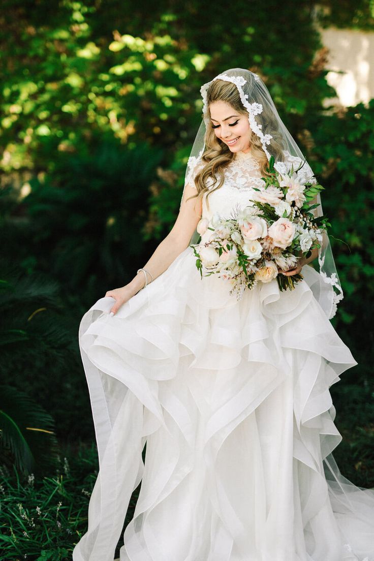 a woman in a wedding dress holding a bouquet