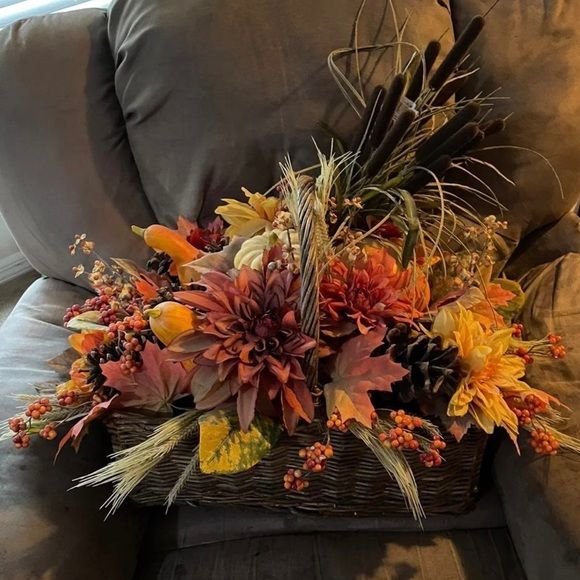 a basket filled with flowers sitting on top of a couch