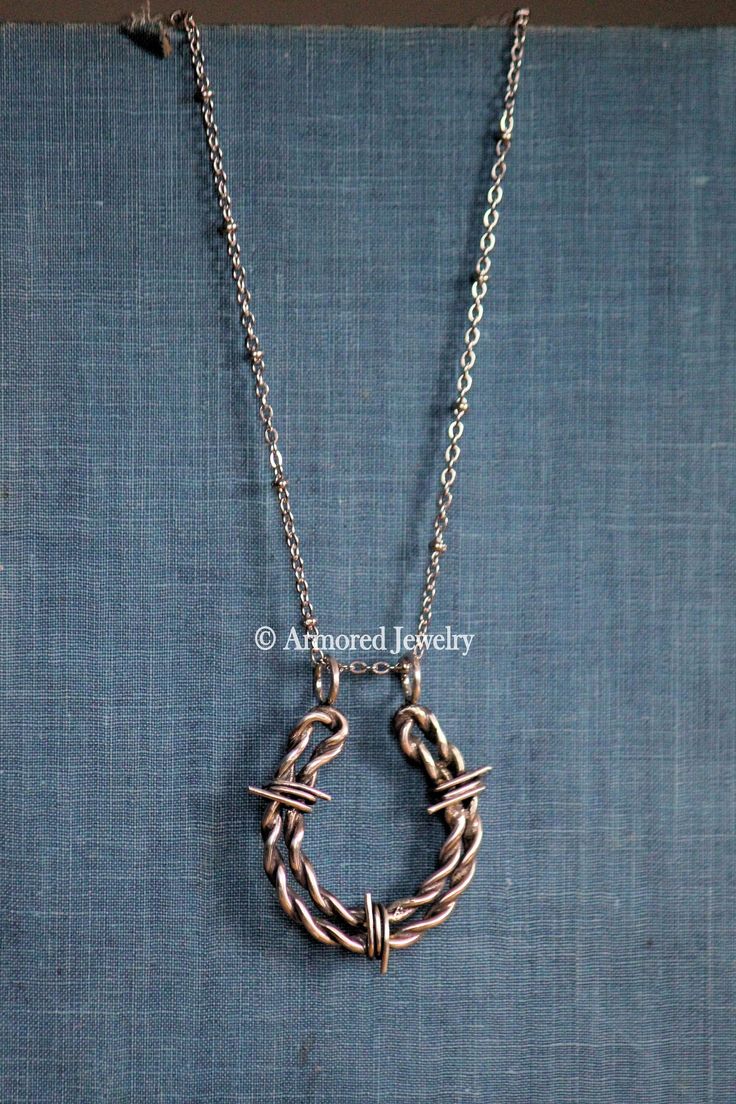 Sterling Silver Horseshoe Barbed Wire Pendant This is a beautiful handmade horseshoe shaped barbed wire pendant. It features a beautiful and unique barbed wire design shaped like a horseshoe. These are handmade from start to finish and each pair will be unique. No two pairs will be exactly the same! **THIS IS AN ARMORED JEWELRY ORIGINAL DESIGN! The horseshoe shape measures 1 1/2" tall x 1 1/8" wide including the loops on top. You can choose to have it darkened (as pictured), which brings out the Wire Wrapped Horseshoe, Adjustable Rustic Jewelry With Oxidized Finish, Rustic Adjustable Jewelry With Oxidized Finish, Artisan Metal Hoop Jewelry, Artisan Hand Wrapped Jewelry With Round Pendant, Artisan Hand-wrapped Round Pendant Jewelry, Artisan Hand Wrapped Round Pendant Jewelry, Adjustable Rustic Metal Jewelry, Silver-colored Copper Hoop Jewelry