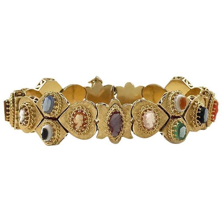 Victorian Revival 14 Karate Yellow Gold Cameo Slide Bracelet. Portrait silhouettes of both men and women on each charm, except one charm on the end, which is a marquise cut opal. Beautiful gold detail on each cameo setting, there is a Florentine finish on each multi-shaped gold charm and a prong-set gemstone or shell cameo. Gemstones include opal, coral, and tiger's eye plus mother of pearl and shell. The bracelet is in near pristine condition. The weight of the bracelet is 46.4 grams. Unique Jewelry Vintage, Victorian Bracelet, Slide Bracelet, Vintage Charm Bracelet, Gold Link Bracelet, Antique Bracelets, Victorian Gold, Accessories Diy Jewelry, Victorian Jewelry