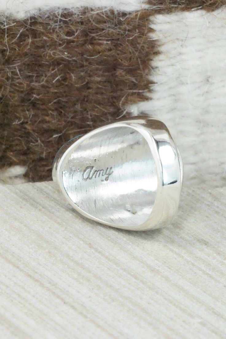 This turquoise and sterling silver inlay ring was made by Zuni silversmith Amy Wesley. The inside is signed Amy.Size: 10Length: 1 1/8"Width: 5/8"Free shipping on all orders! We ship with USPS and always include tracking. All orders ship within a day of payment.Returns are accepted up to 30 days after you receive your order. Just send us a message. Our shop offers cash back or store credit. The item must be returned in the same condition. Classic Sterling Silver Turquoise Ring With Polished Finish, Southwestern Style Engraved Turquoise Ring As Gift, Engraved Southwestern Style Turquoise Ring For Gift, Silver Opal Ring With Inlay For Anniversary, Anniversary Silver Opal Ring With Inlay, Sterling Silver Turquoise Ring With Polished Finish For Anniversary, Classic Sterling Silver Turquoise Ring For Anniversary, Polished Turquoise Ring For Anniversary, Classic Turquoise Ring Stamped 925 As Gift