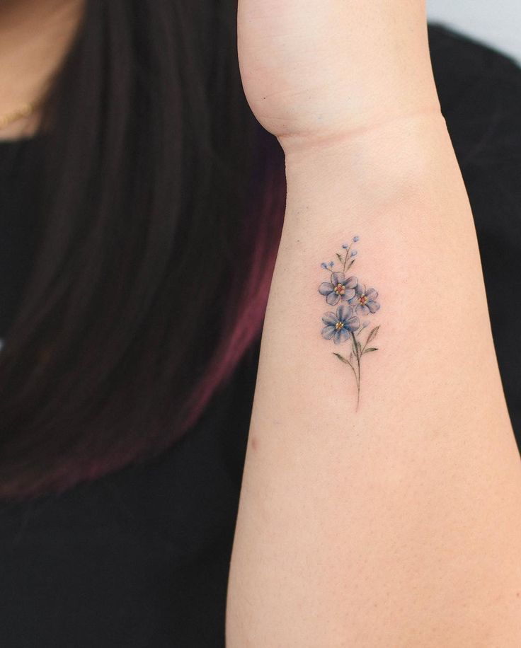 a woman with a small tattoo on her arm