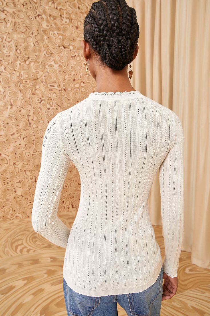 A layer-friendly beauty, our Delia Top is spun from the finest cotton and silk into a dynamic pointelle knit inspired by antique textiles. Imbued with a hint of stretch, this long-sleeve style has a classic crewneck, a close fit, and is a pearly white hue for optimal versatility. It fastens with a button front placket. Composition: 60% Silk, 40% Cotton Pair with our Willow Jean to complete the look. Feminine Long Sleeve Sweater In Pointelle Knit, Feminine Long Sleeve Pointelle Knit Sweater, Elegant Long Sleeve Open Knit Top, Feminine Long Sleeve Open Knit Top, Elegant Crew Neck Top In Pointelle Knit, Elegant Pointelle Knit Sweater For Layering, Crew Neck Pointelle Knit Top For Layering, Fitted Pointelle Knit Sweater For Layering, Open Knit Long Sleeve Sweater For Daywear