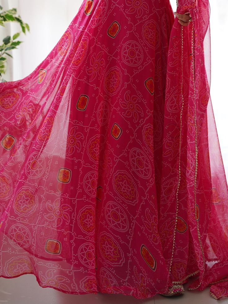 Introducing our stunning "pretty pink bandhani printed chiffon festival wear gown with dupatta" - a must-have for your festive wardrobe! This beautiful pink color gown features intricate bandhani print work, adding a touch of traditional charm. The chiffon fabric adds a touch of elegance, making it perfect for festivals, functions, and special events.
The matching chiffon dupatta with bandhani print work and fancy lace border work completes the look, giving you a coordinated and stylish outfit. Pink Dress With Printed Motifs And Traditional Drape, Pink Sharara With Printed Motifs And Traditional Drape, Traditional Pink Sharara With Printed Motifs, Bohemian Bandhani Print Georgette Choli, Georgette Saree With Dupatta, Georgette Saree With Dupatta Maxi Length, Festive Pink Sharara With Printed Motifs, Bohemian Bandhani Print Dupatta, Bohemian Bandhani Print Floor-length Dupatta