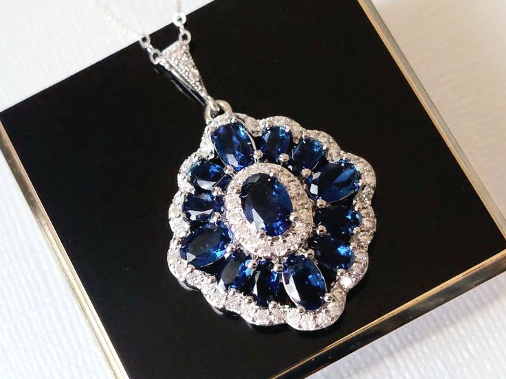 Wedding Navy Blue Sapphire Dark Blue Clear Cubic Zirconia Halo Pendant Necklace with .925 Sterling Silver Chain. CHAIN is 20 inches (50.8cm) long. PENDANT is about 1.37 inch (3.5cm) long including bail. BRIDAL NECKLACES SECTION: https://www.etsy.com/shop/LanaChayka?ref=seller-platform-mcnav&section_id=11638944 NECKLACES SECTION: https://www.etsy.com/shop/LanaChayka?ref=seller-platform-mcnav&section_id=17026331 Glamorous and elegant, this necklace is perfect for weddings or special occasions such Sapphire Cubic Zirconia Jewelry For Wedding, Sapphire Cubic Zirconia Wedding Jewelry, Sapphire Cubic Zirconia Bridal Necklace Gift, Sapphire Crystal Jewelry For Wedding, Royal Blue Crystal Jewelry For Wedding, Sapphire Cubic Zirconia Bridal Necklace For Wedding, Sapphire Crystal Bridal Necklace Gift, Sapphire Cubic Zirconia Bridal Necklace, Wedding Sapphire Jewelry