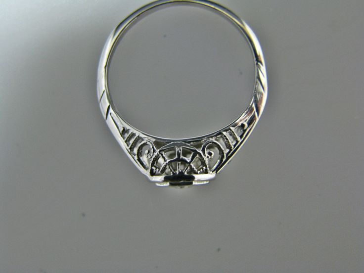 "For Sale: (1) H108 Gorgeous Diamond Ring in 14k White Gold from 1930's PLEASE READ ENTIRE DESCRIPTION BEFORE PURCHASING Please see pictures for more details! This stunning ring features a center 0.06 ct diamond. This is a beautiful filigree mounting down the side. The shank is decorated half way down. The ring is not stamped 14k, but was tested for it. This ring is from the 1930's. A beautiful piece for a any special occasion! What a great Gift! Specifics: *14k White Gold *Center Diamond approx 14k Gold Art Deco Jewelry, Classic Engraved Platinum Jewelry, Art Deco Oval Sapphire Ring With Prong Setting, Art Deco Jewelry With Round Diamond Cut, Art Deco Round Engraved Jewelry, Art Deco Engraved Round Jewelry, Classic Platinum Jewelry Stamped 14k, Vintage Sapphire Ring With Diamond Cut, Oval Shape, Art Deco White Gold Rings Stamped 14k