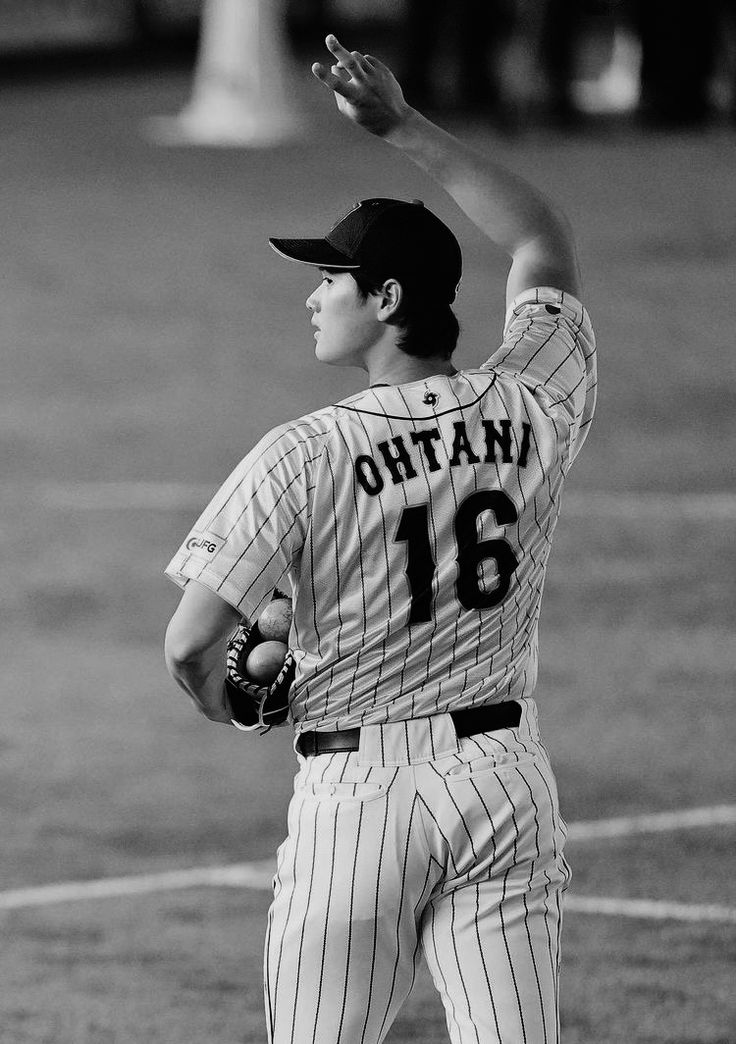 black and white photograph of a baseball player about to throw the ball