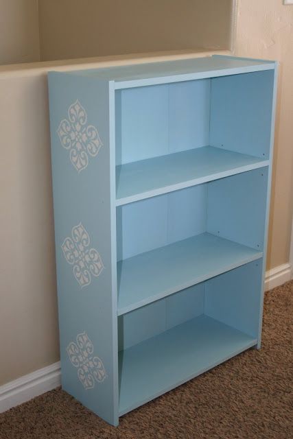 a blue book shelf sitting in the corner of a room