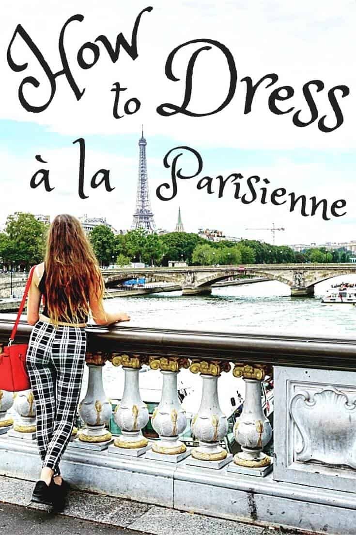 a woman is sitting on a bridge looking at the eiffel tower in paris