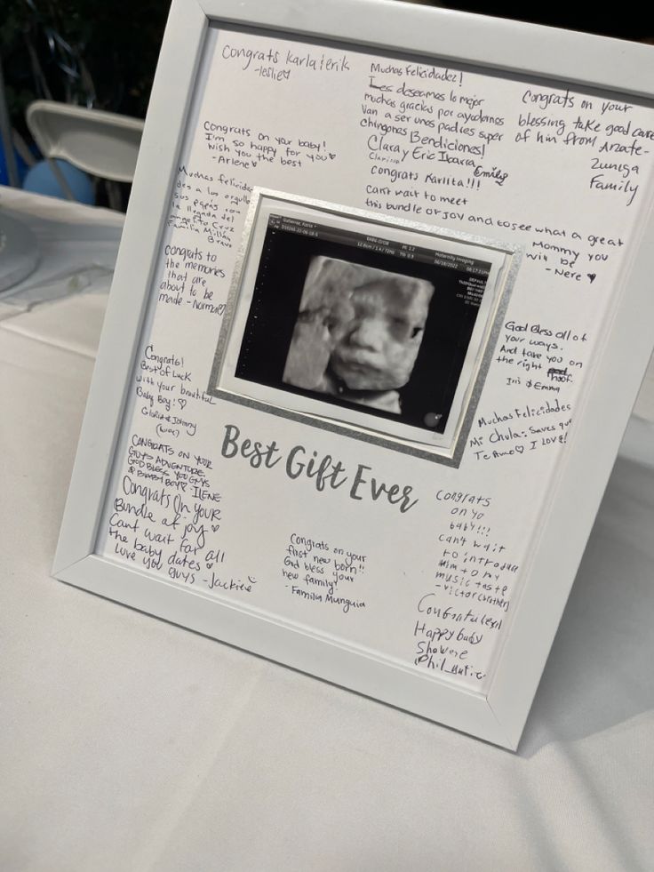 a white frame with writing on it that says best gift ever and an image of a baby's head