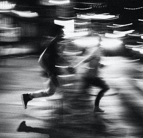 blurry image of people running in the street with words that read'me '