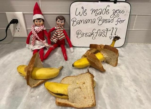 two elfs are sitting next to some bread and bananas