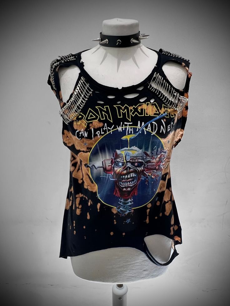 THE STITCHES Distressed Rock collection - This Iron Maiden is a handmade bleached crop top/t-shirt made with a brand new officially licensed band shirt. - Distressed Iron Maiden crop top/shirt - Safety pin unisex hand-made crop/tee - Material: Bleached cotton Measurements - Fit UK 8-12, US4-8 - Width (armpit to armpit) : 18 Inches  - Length (top of collar to bottom): 25 inches Care instructions: - This is a distressed item and will require proper care, it should be washed inside out gently and h Edgy Graphic Print Tops For Festivals, Alternative Acid Wash Top With Screen Print, Rocker Style Fan Merchandise Tops For Summer, Edgy Fan Merchandise Tops, Acid Wash Stonewashed Tops For Band Merch, Acid Wash Alternative Style Tops For Alternative Fashion, Acid Wash Grunge Top For Music Festival, Edgy Acid Wash Tops For Alternative Fashion, Distressed Tops For Halloween Alternative Fashion