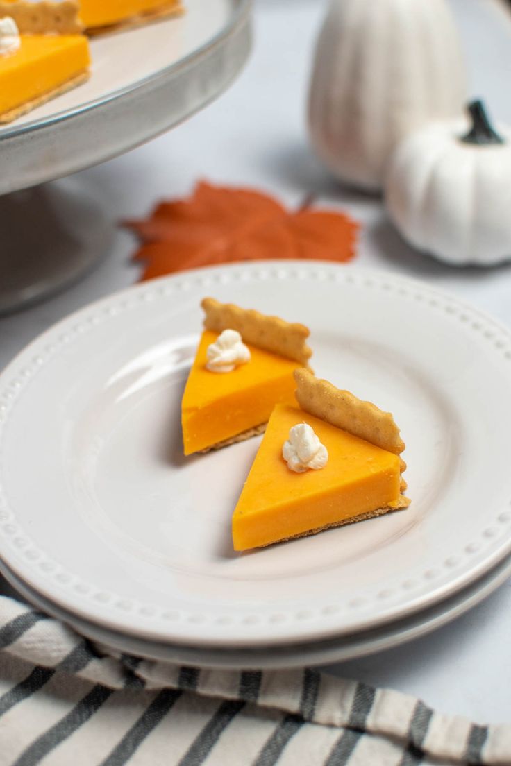 two slices of pumpkin pie on a white plate