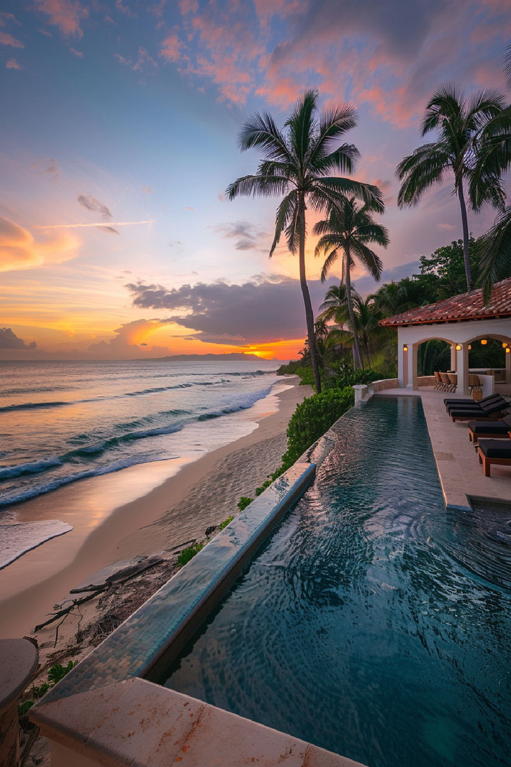 A stunning beachfront villa in Puerto Rico with a private infinity pool overlooking a picturesque sunset, framed by tall palm trees and a serene coastline. Puerto Rico Mansion, Puerto Rico Beach House, Luquillo Beach Puerto Rico, Puerto Rico Honeymoon, Old San Juan Puerto Rico Aesthetic, Puerto Rico Airbnb, Houses In Puerto Rico, Cuba House, Puerto Rico House