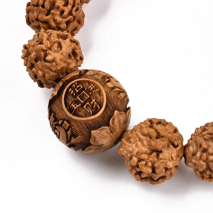 Introducing our latest addition - the Rudraksha Bracelet with 15mm beads! This stunning piece not only looks great but also has spiritual significance. Rudraksha beads are believed to have healing properties and can bring peace and clarity to the wearer. Get yours today and experience the positive energy it brings. The rudraksha is the perfect choice for conquering your enemies and also to enjoy a sound physical and mental health. Anyone, irrespective of gender, cultural, ethnic, geographical or Spiritual Carved Beaded Bracelets, Spiritual Carved Beaded Bracelets, Adjustable, Adjustable Carved Beaded Spiritual Bracelets, Adjustable Carved Beaded Bracelets For Spiritual Style, Spiritual Carved Adjustable Bracelets, Spiritual Adjustable Carved Bracelets, Spiritual Meditation Bracelets, Traditional Carved Beaded Bracelets As Gift, Traditional Carved Beaded Bracelets For Gift