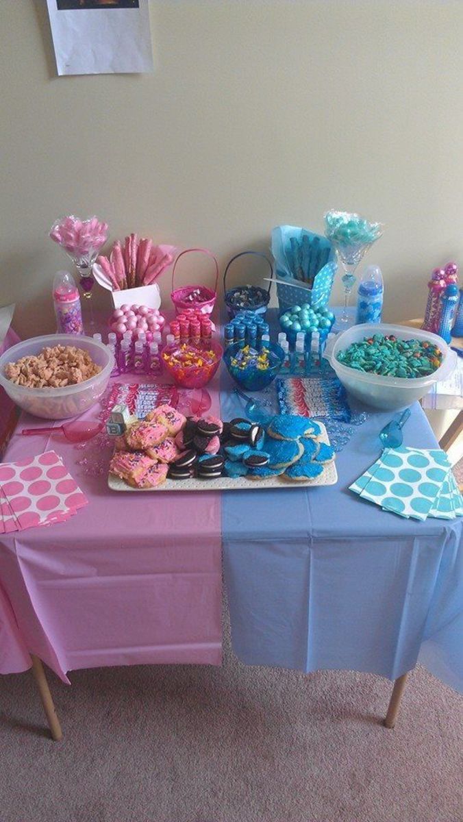 a table topped with lots of candy and candies on top of a blue table cloth