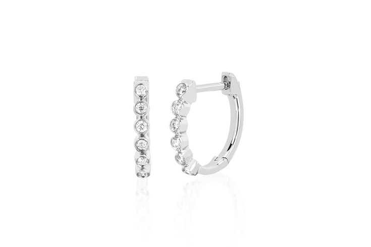 Our diamond bezel huggie earring features 0.11 carats of diamond set in 14k gold. Sold as a pair Diameter measures: 12mm Inner huggie diameter: 10mm Formal Cubic Zirconia Hoop Earrings With Single Diamond, Elegant Formal Huggie Earrings With Single Diamond, Elegant Diamond White Huggie Earrings With Single Cut Diamonds, Silver Diamond Hoop Earrings With Single Diamond, Classic Sterling Silver Huggie Earrings With Single Diamond, Formal White Gold Huggie Earrings With Single Diamond, Elegant Single Diamond Hoop Earrings For Formal Occasions, Elegant White Gold Diamond Earrings With Bezel Setting, Classic Formal Huggie Earrings With Single Cut Diamonds