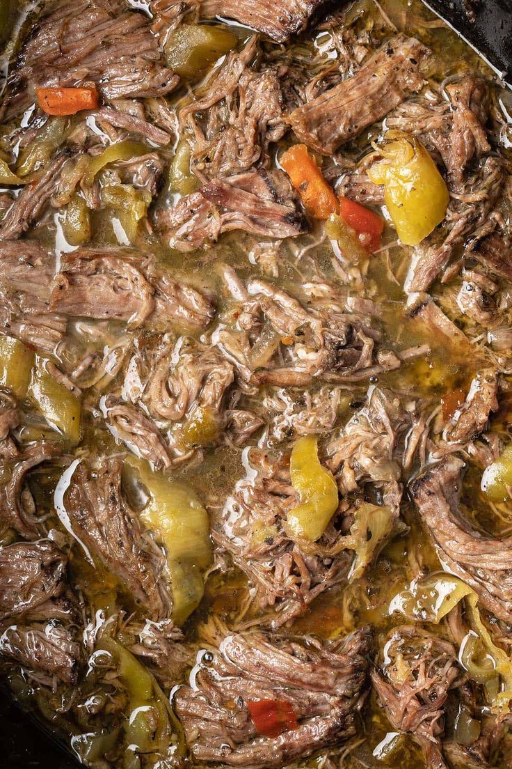 a pot filled with meat and vegetables on top of a stove